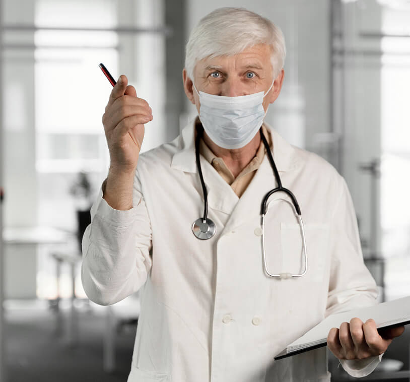 A male doctor looking into the camera.