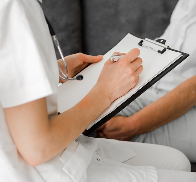 A doctor is filling out some patient document.