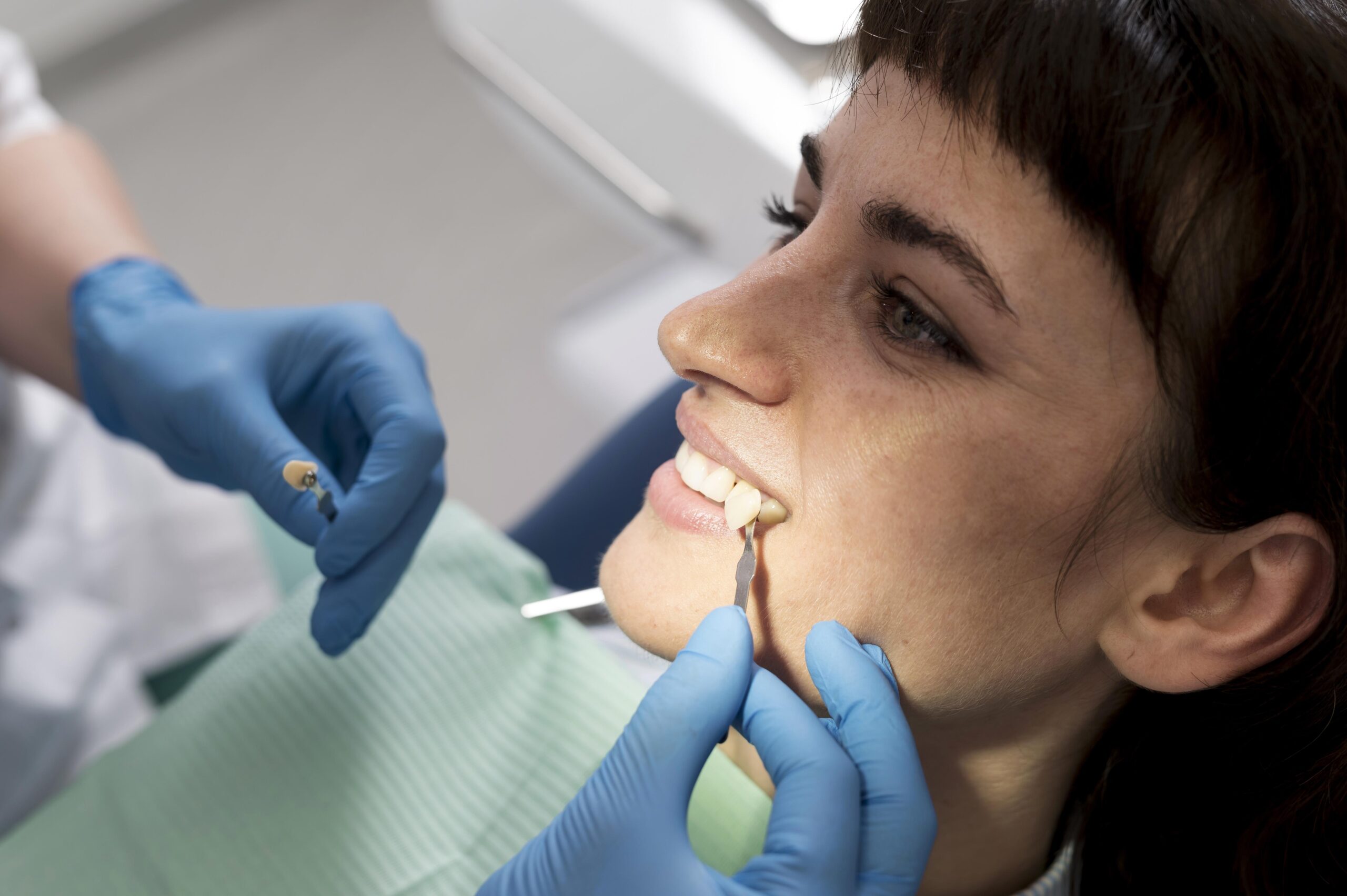 Close up of patient, receiving dental treatment during her dental implant process.